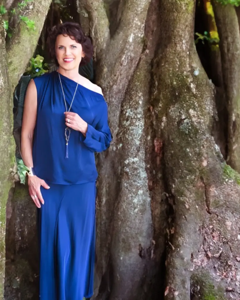Marcella Scherer, executive coach and women’s leadership strategist, outdoors beneath a banyan tree